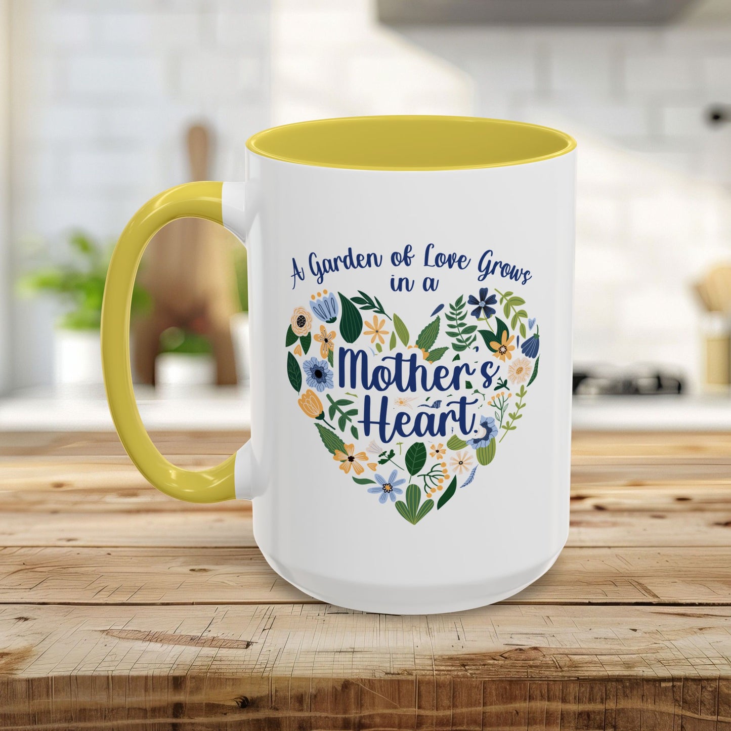White ceramic mug with yellow handle and interior, featuring a floral heart design and "A Garden of Love Grows in a Mother's Heart" text.