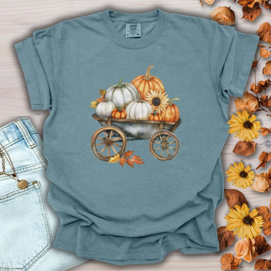 Ice Blue S-size cotton t-shirt with a watercolor rustic wagon piled with white and orange pumpkins and sunflowers.