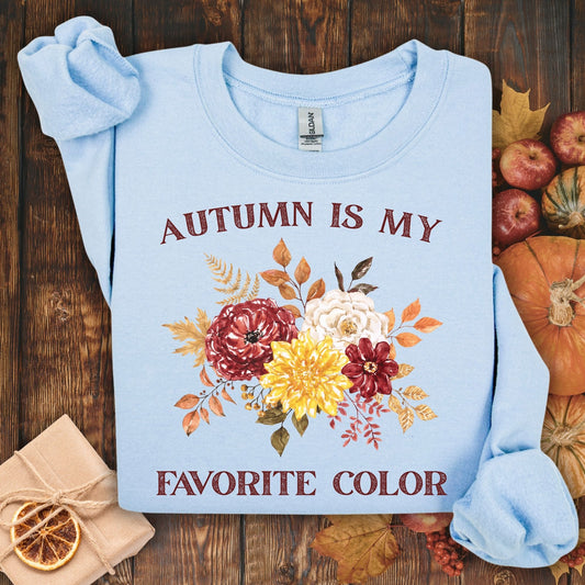 Light blue Gildan sweatshirt with "Autumn is My Favorite Color" text and watercolor fall flowers.