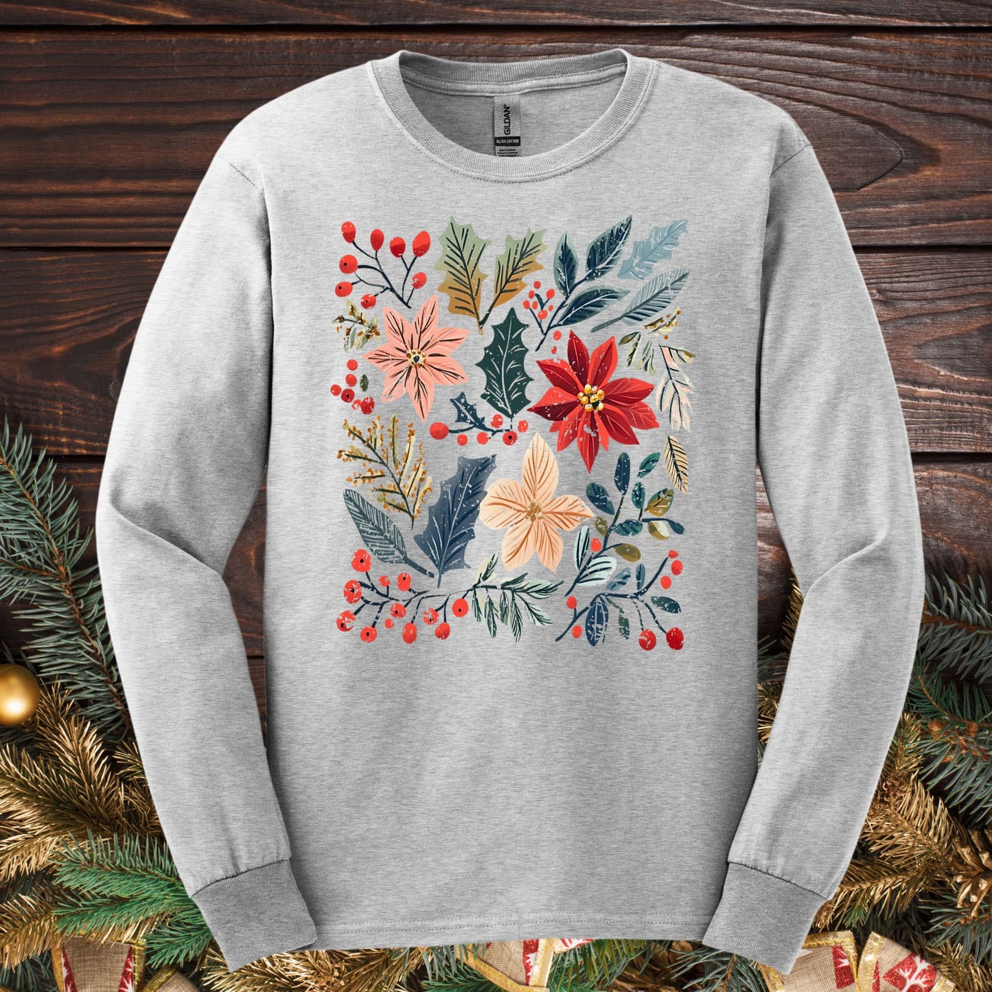 Ash gray long sleeve tee with a vibrant boho poinsettia floral design, rustic details, and red berries.