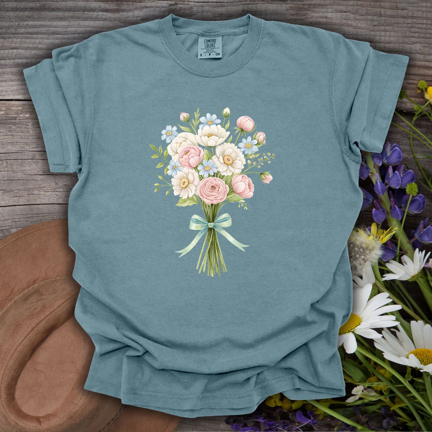Ice Blue S t-shirt with a watercolor floral bouquet of pink and white blooms tied with a blue ribbon.