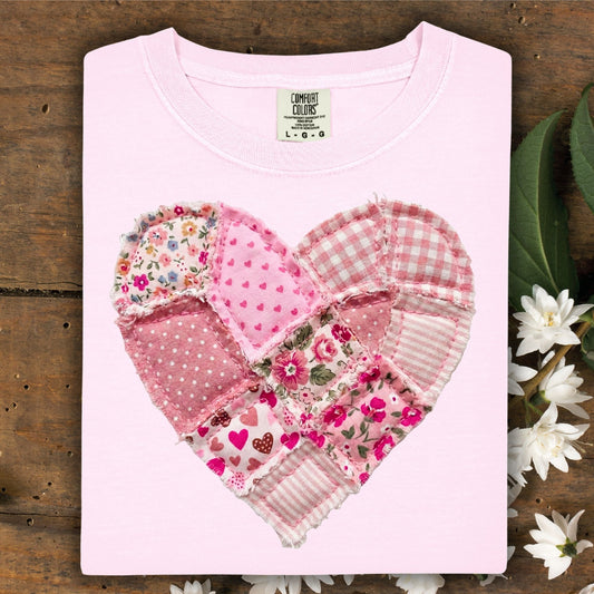 Blossom pink garment-dyed cotton t-shirt with a cottagecore faux patchwork heart in warm pinks and cream.