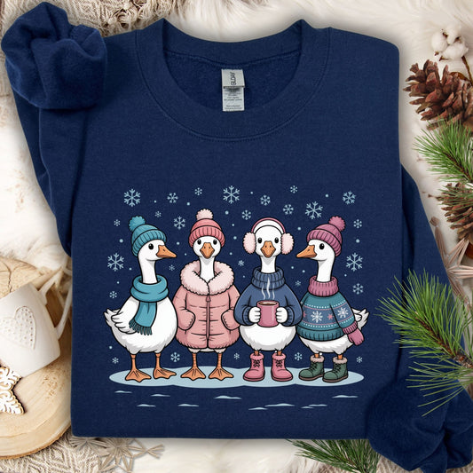 Navy S sweatshirt with four cute geese in winter sweaters, hats, and mittens, drinking hot chocolate in snow.