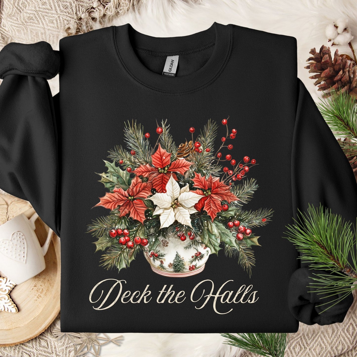 Black Gildan sweatshirt with a watercolor poinsettia bouquet in a vase and "Deck the Halls" text.
