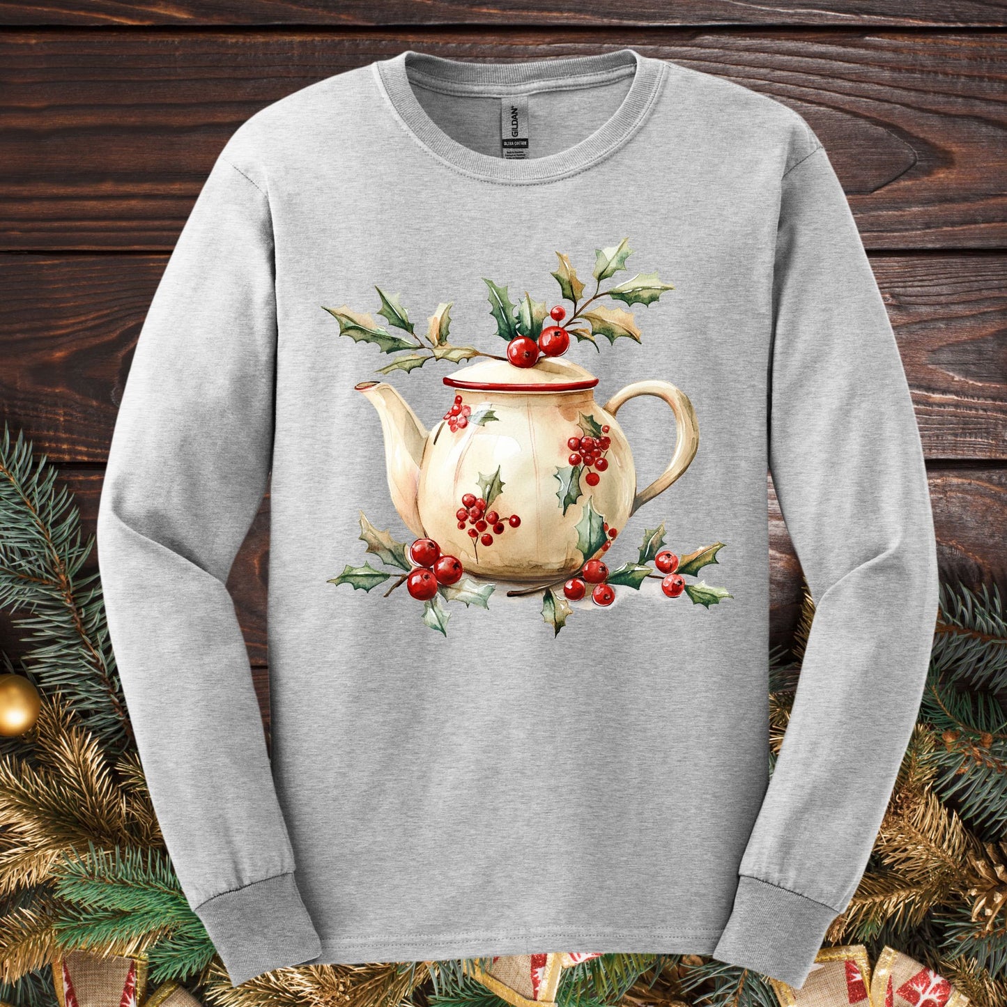 Ash long sleeve tee with a watercolor farmhouse Christmas teapot, holly, and evergreens design.