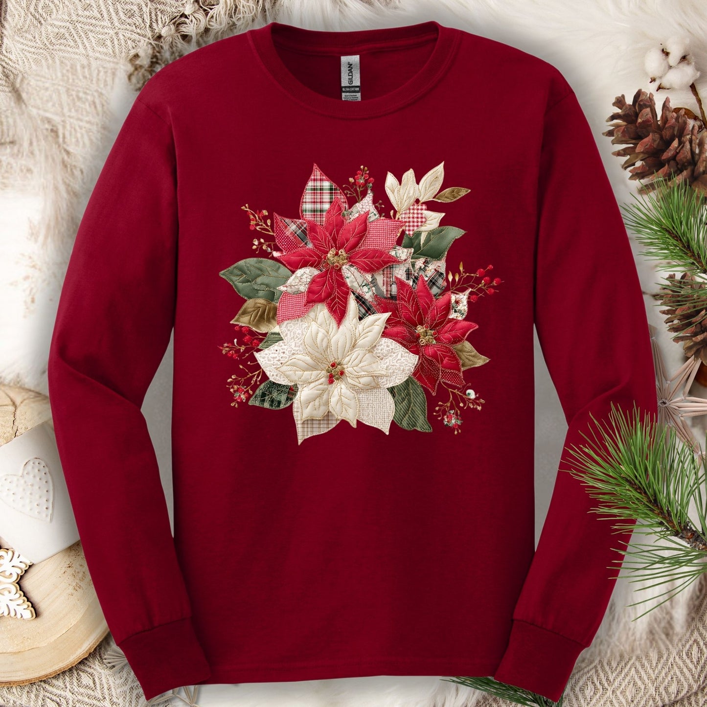 Cardinal Red long sleeve tee with a faux patchwork poinsettia design featuring red, white, gingham, and plaid.