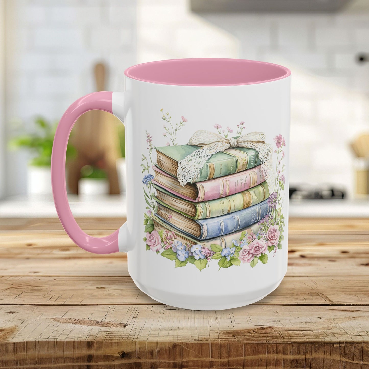 White ceramic mug with pink handle and interior, featuring a watercolor stack of vintage books and roses.