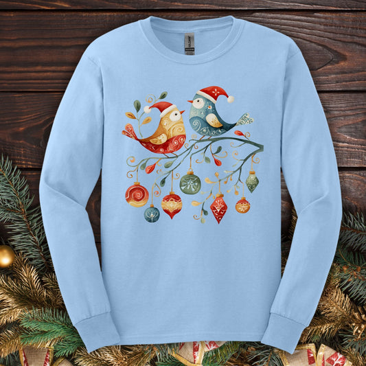 Light blue long sleeve tee with folk art Christmas birds, ornaments, and festive branch.