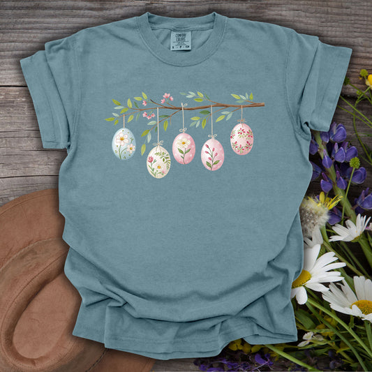 Ice Blue garment-dyed cotton t-shirt with a folk art Easter egg branch design.