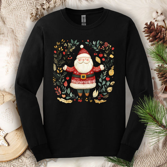 Black Gildan Softstyle long sleeve tee with folk art Santa in a wreath of evergreen, holly, and berries.