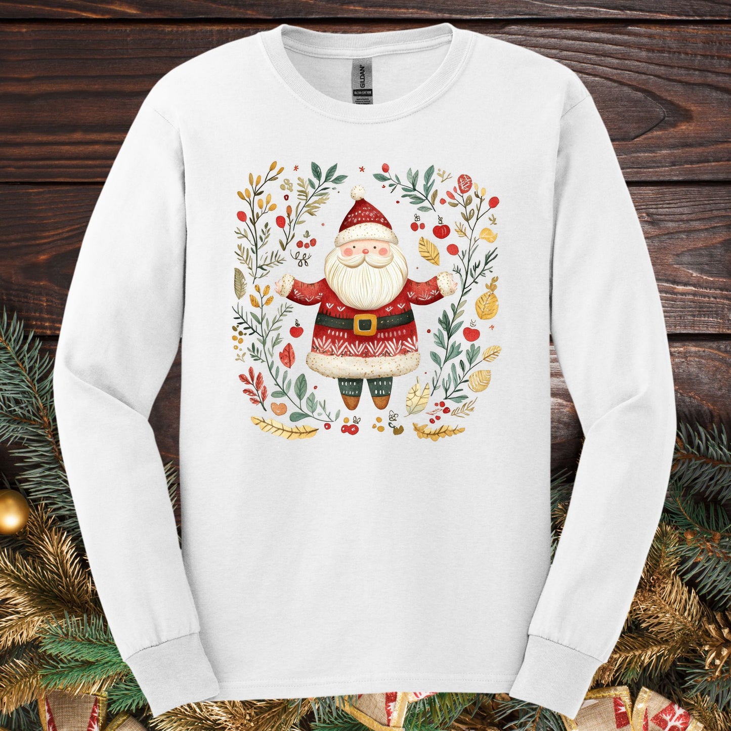 White Gildan Softstyle long sleeve tee with a folk art Santa in a festive wreath design.