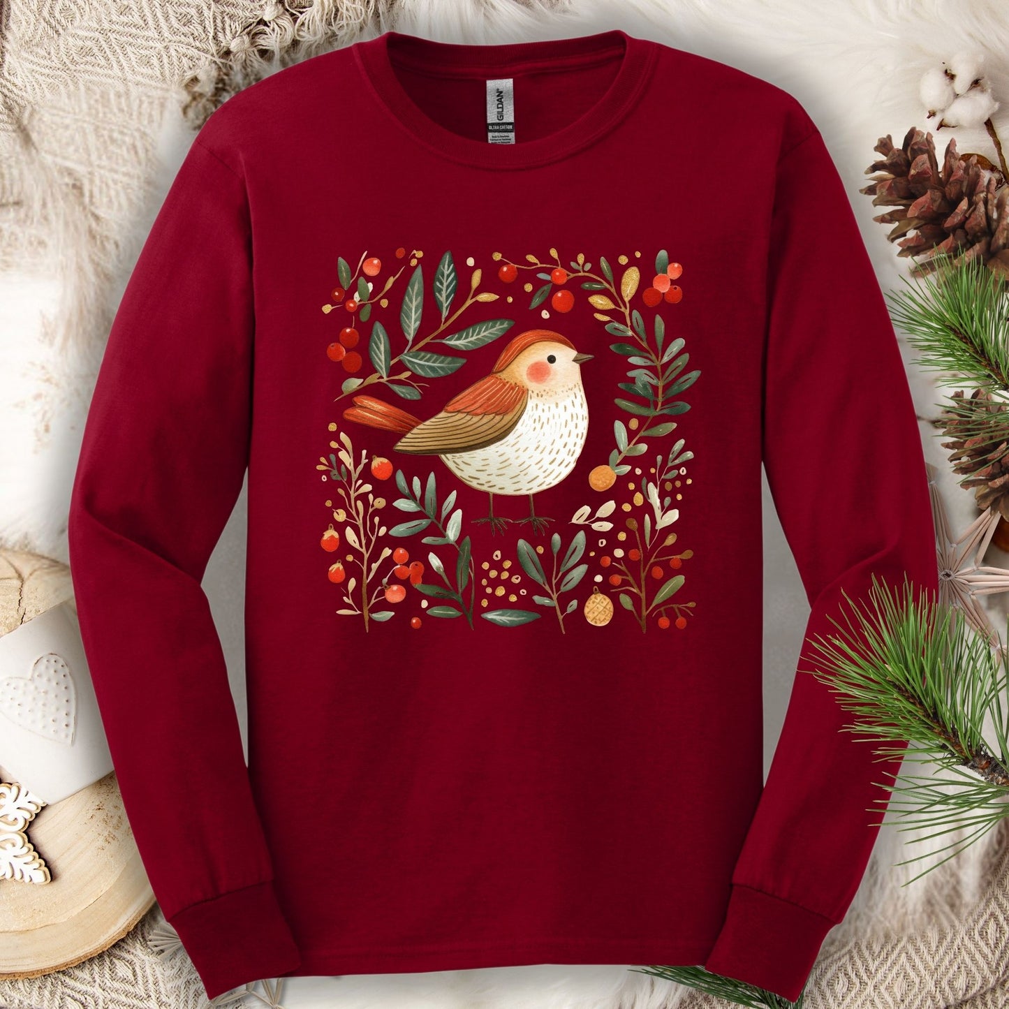 Cardinal Red Gildan long sleeve tee with folk art winter sparrow, evergreens, holly, and ornaments.