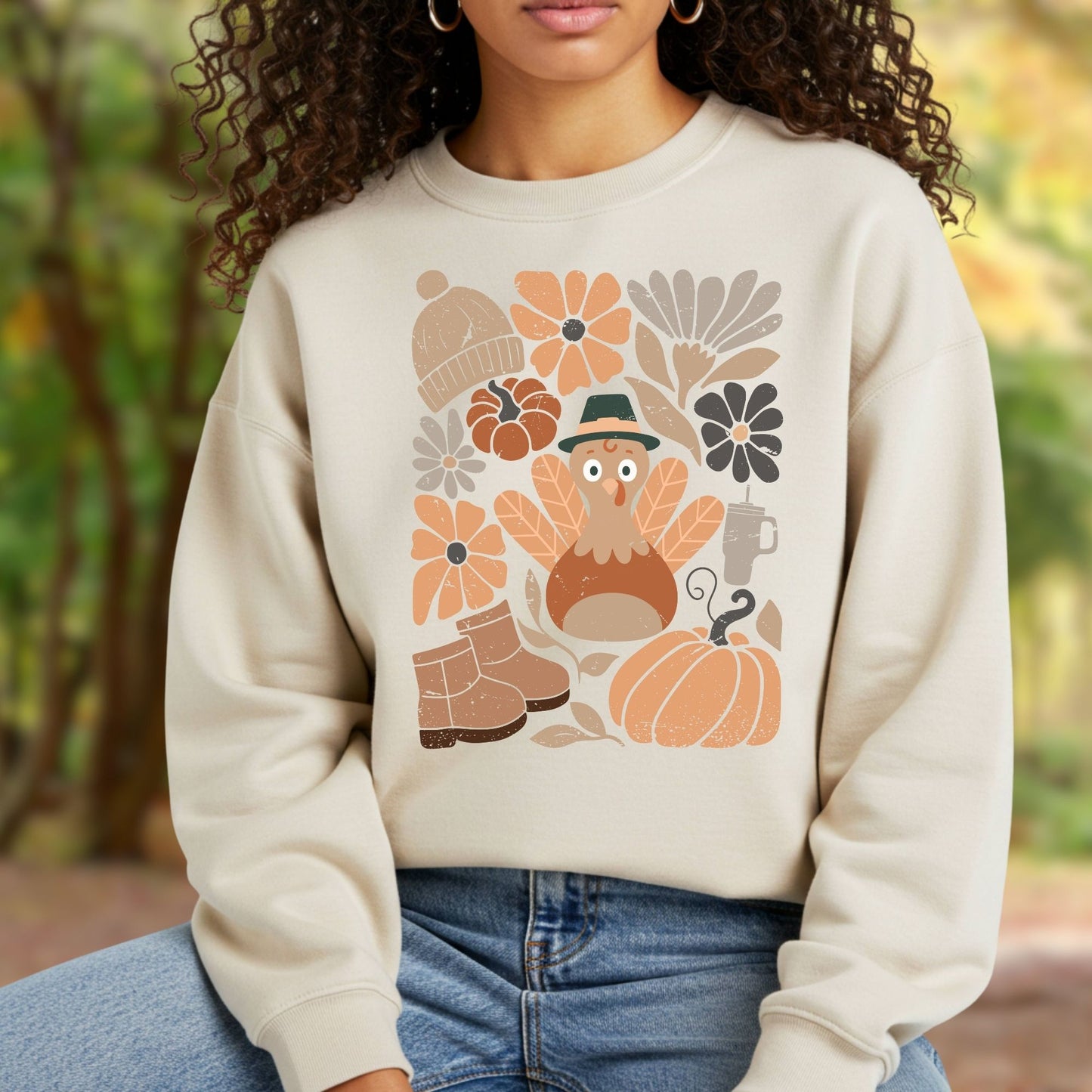 Groovy turkey sweatshirt in cream, featuring autumn leaves, boots, hat, and rustic florals.
