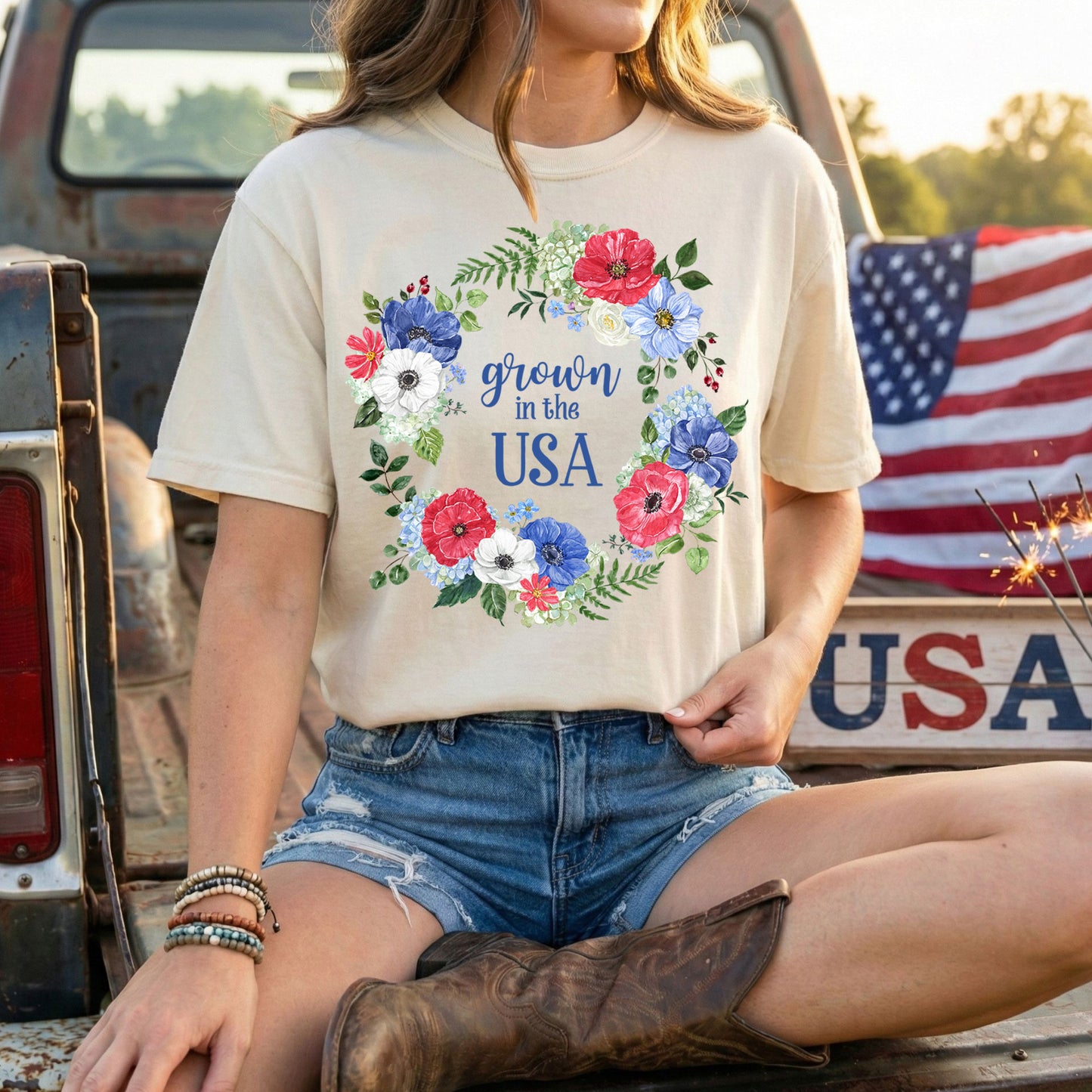 Garment-dyed cream t-shirt with a red, white, and blue floral wreath surrounding "Grown in the USA.