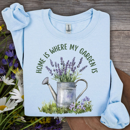Light blue crewneck sweatshirt with "Home is where my garden is" text and a watercolor watering can with lavender.