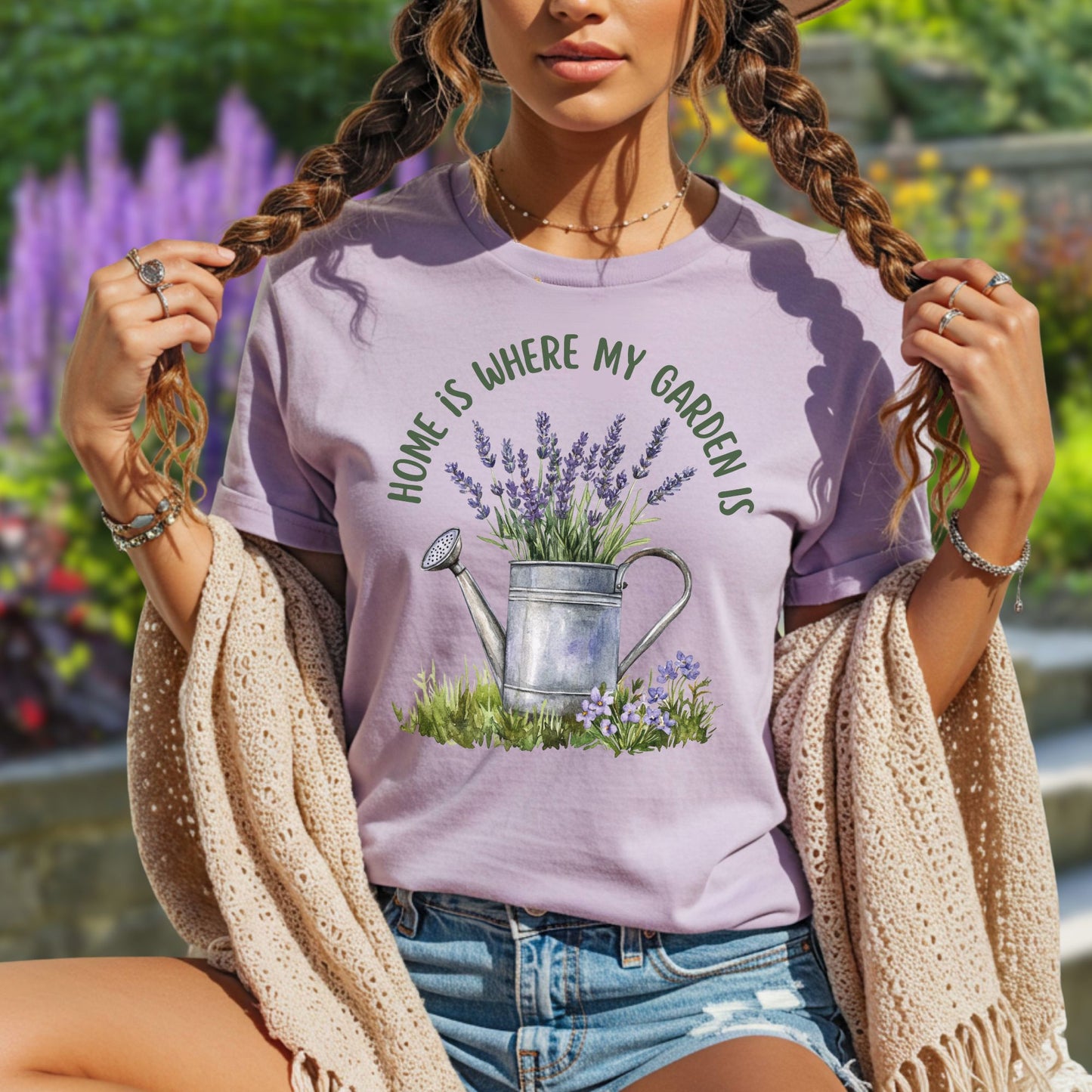 Lavender garment-dyed cotton t-shirt with a watering can and lavender graphic, "Home Is Where My Garden Is" text.