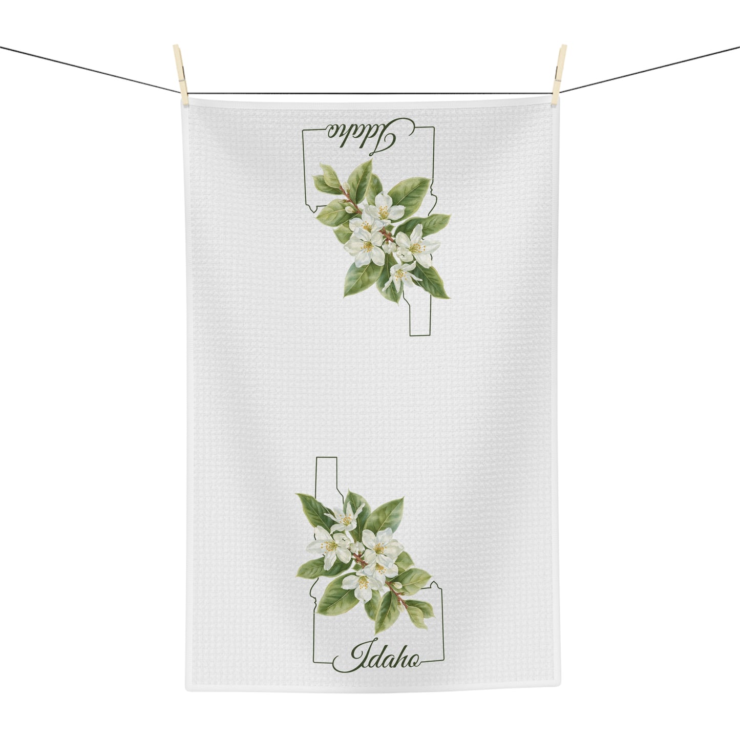 White microfiber tea towel with Idaho state outline and Syringa (mock orange) blossoms.
