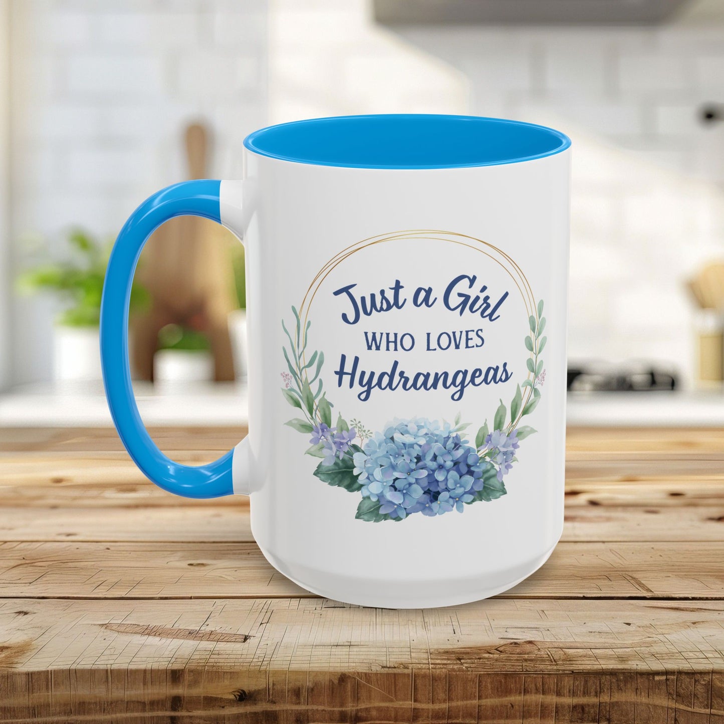 White ceramic mug with blue interior and handle, featuring a watercolor hydrangea wreath and "Just a Girl Who Loves Hydrangeas" text.