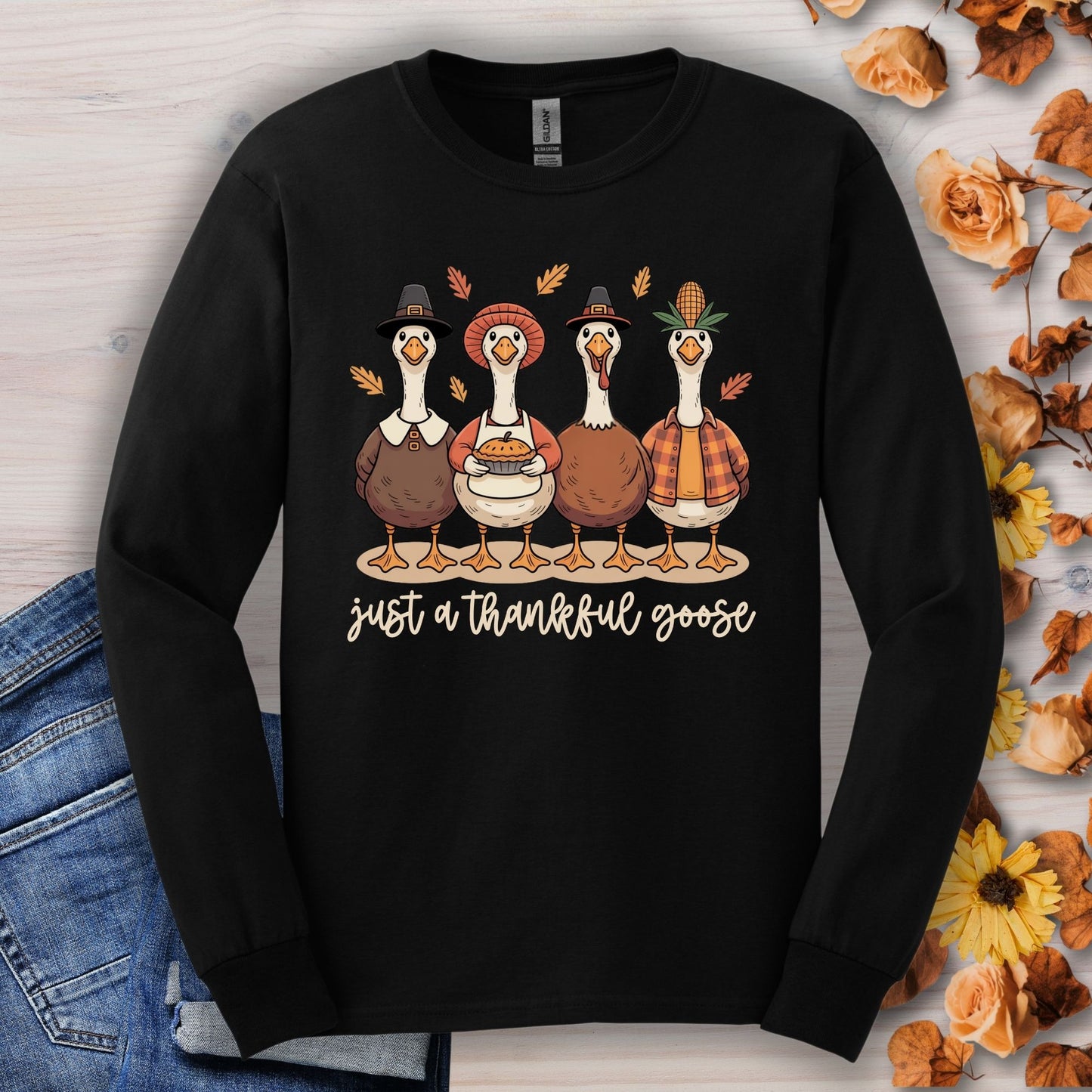 Black long sleeve tee with "Just a Thankful Goose" text and four pilgrim ducks eating pumpkin pie.