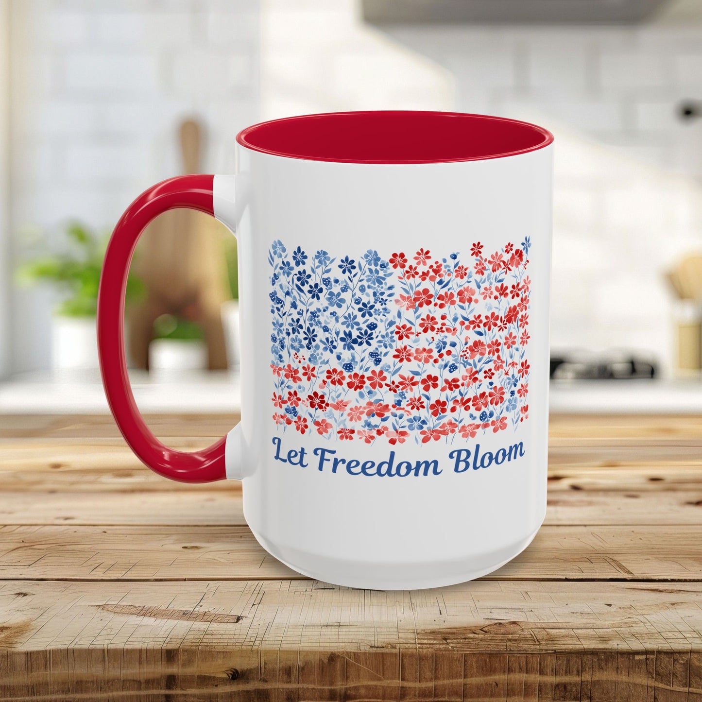 White ceramic mug with red handle and interior, featuring a floral flag design and "Let Freedom Bloom" text.