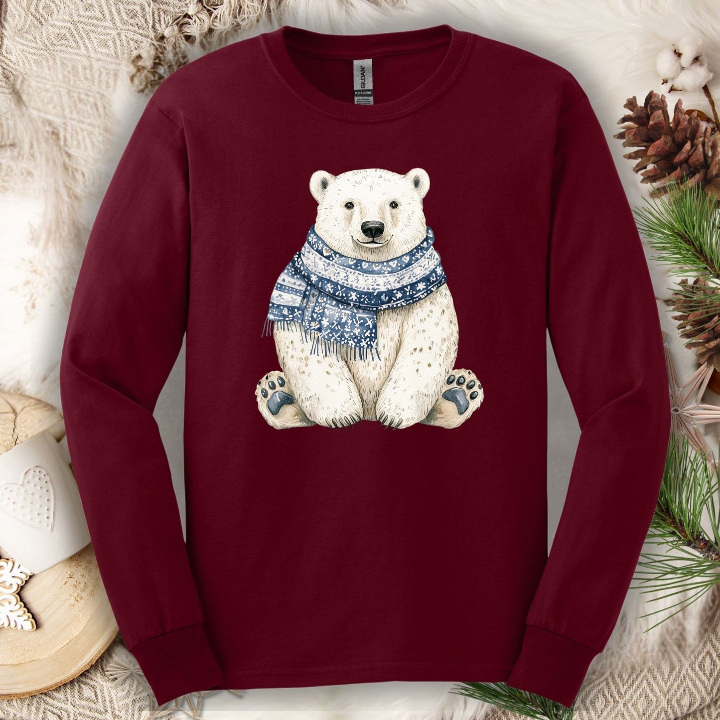 Maroon long-sleeve tee with a hand-painted polar bear wearing a blue knitted scarf.
