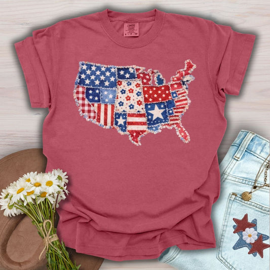 Crimson S t-shirt with a printed faux patchwork map of America, featuring stars, stripes, and floral patterns.