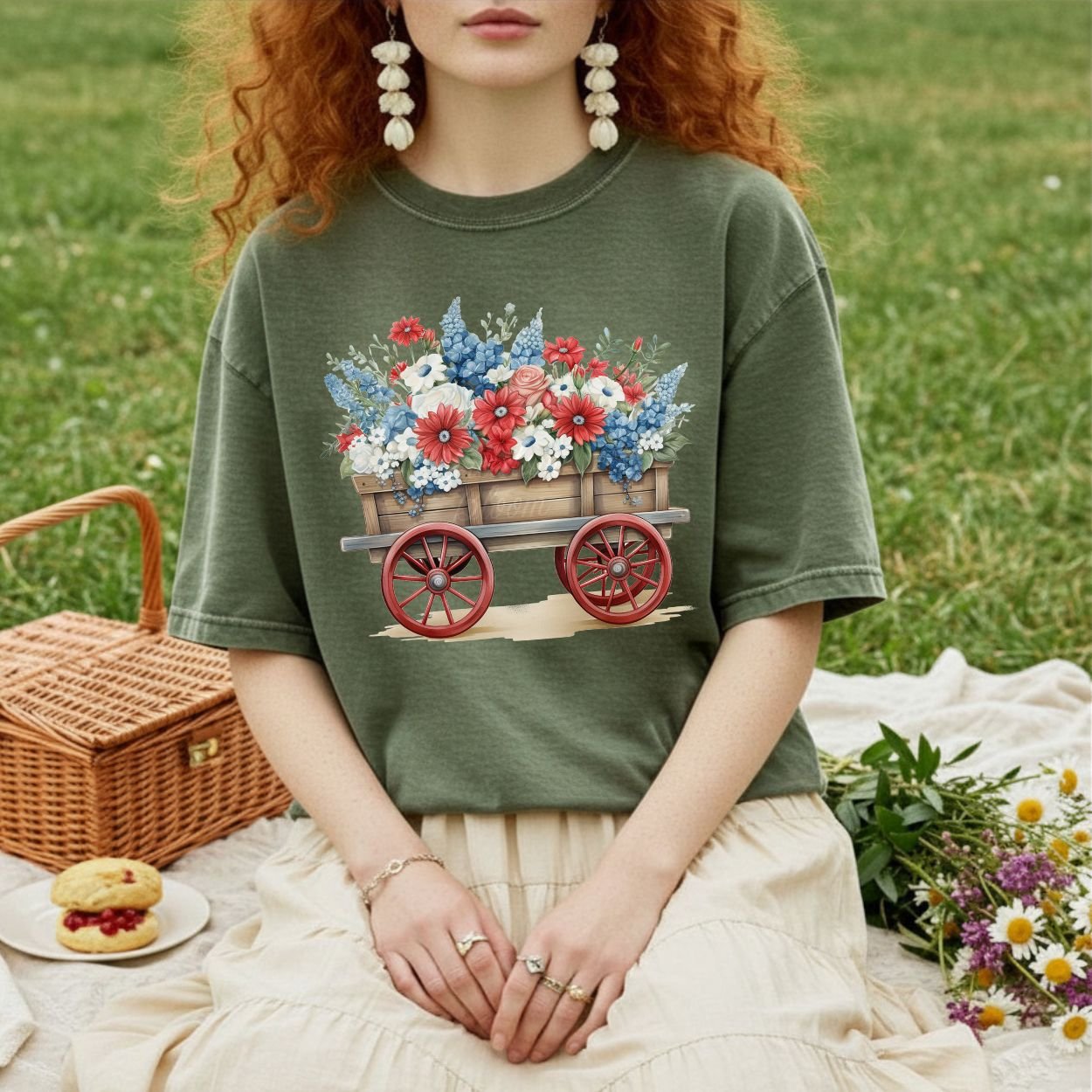 Garment-dyed olive green t-shirt with a hand-painted wagon overflowing with red, white, and blue florals.
