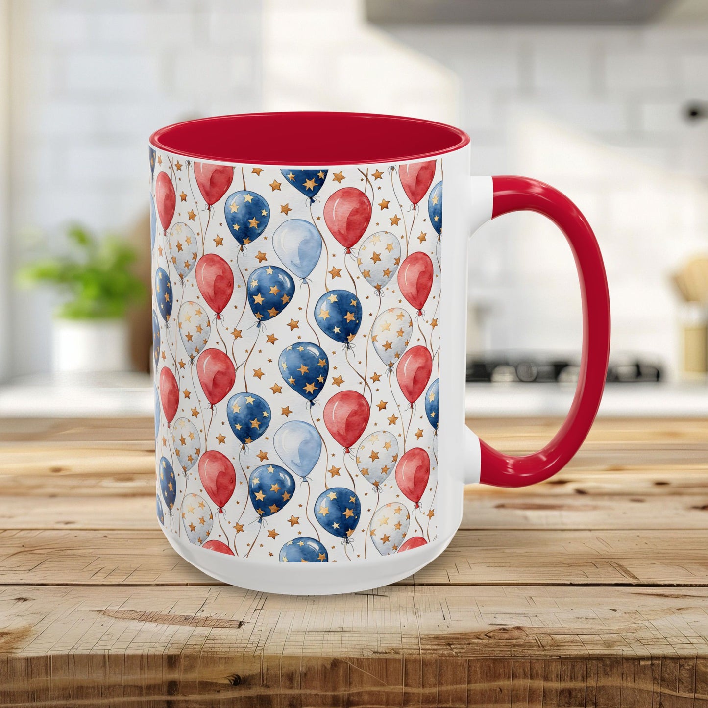 White ceramic mug with red interior and handle, featuring a watercolor-style print of red, white, and blue balloons and gold stars.