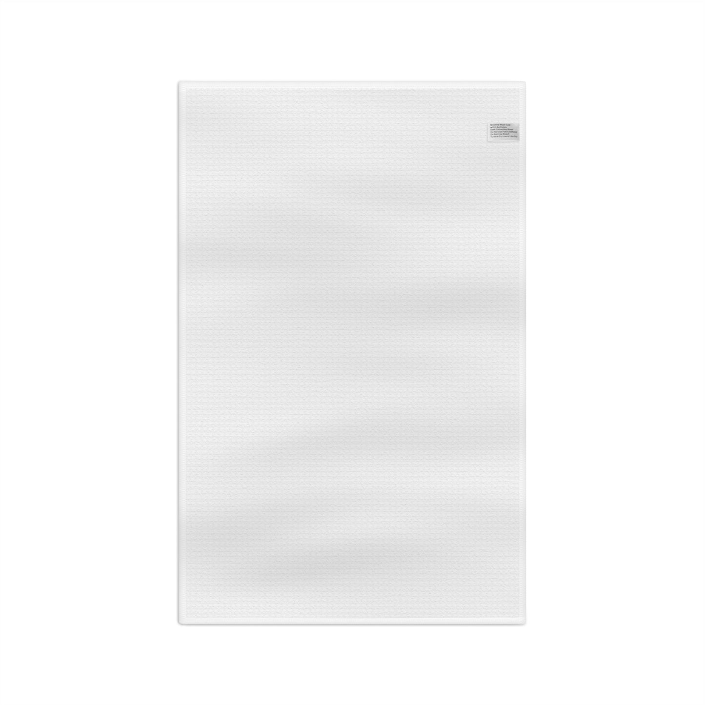 White microfiber tea towel with a subtle waffle texture and a sewn-in care label.