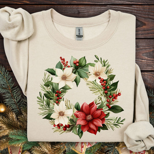 Sand Gildan crewneck sweatshirt with a watercolor poinsettia wreath design featuring red, white, and green flowers.