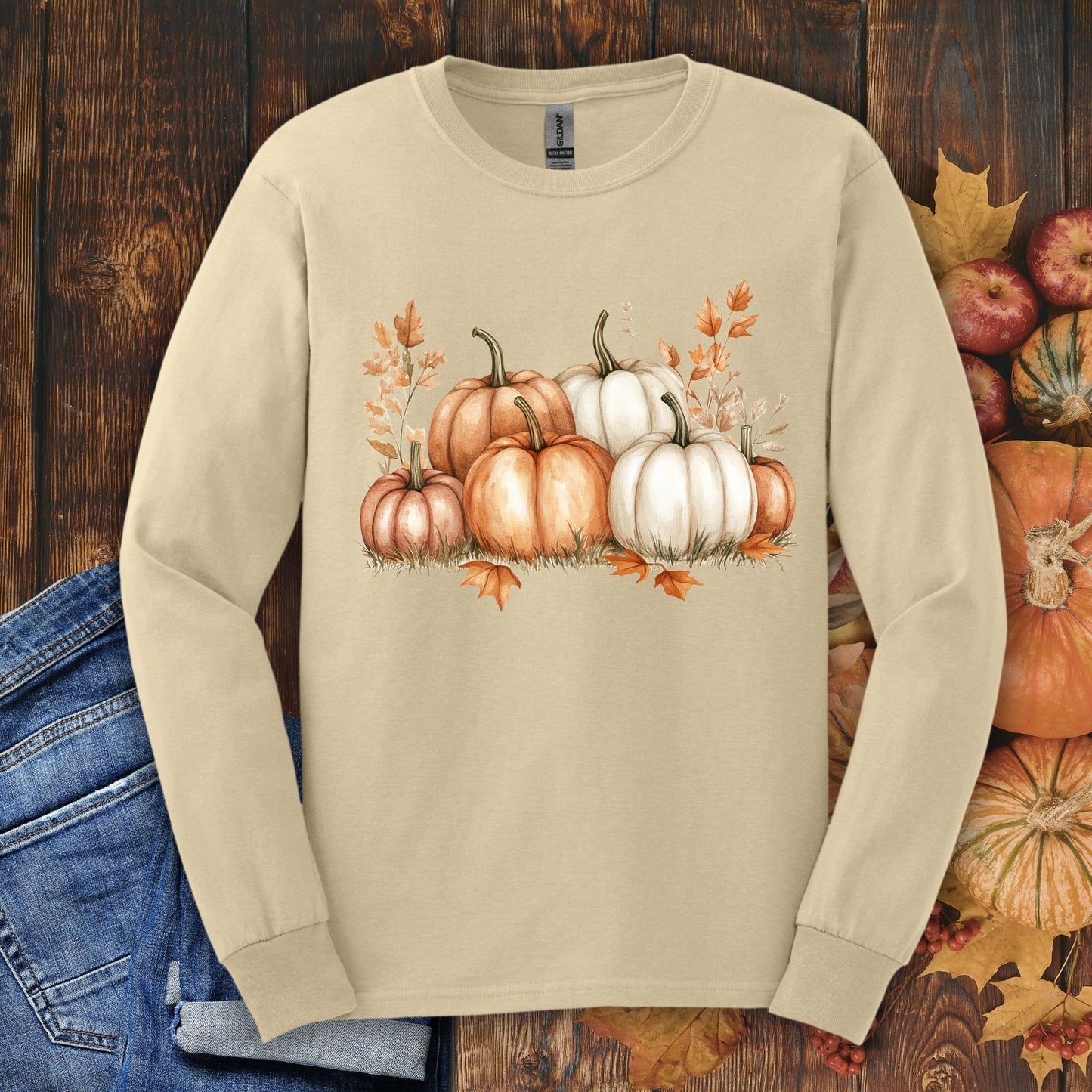 Sand Gildan 2400 long sleeve tee with watercolor orange and white pumpkins, fall leaves, and apples.