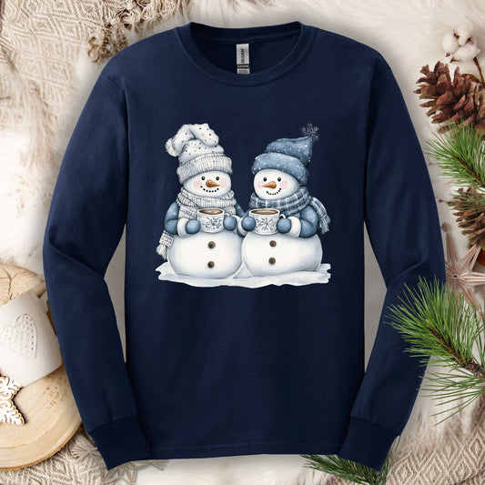 Navy long-sleeve tee with two snowmen in blue hats and scarves holding hot chocolate mugs.