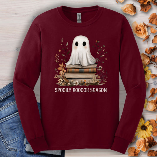 Maroon Gildan long sleeve tee with a boho ghost on books, fall wildflowers, and "Spooky Boooook Season" text.