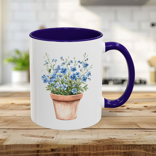 White ceramic mug with blue interior and handle, featuring a watercolor terracotta pot with blue forget-me-nots.
