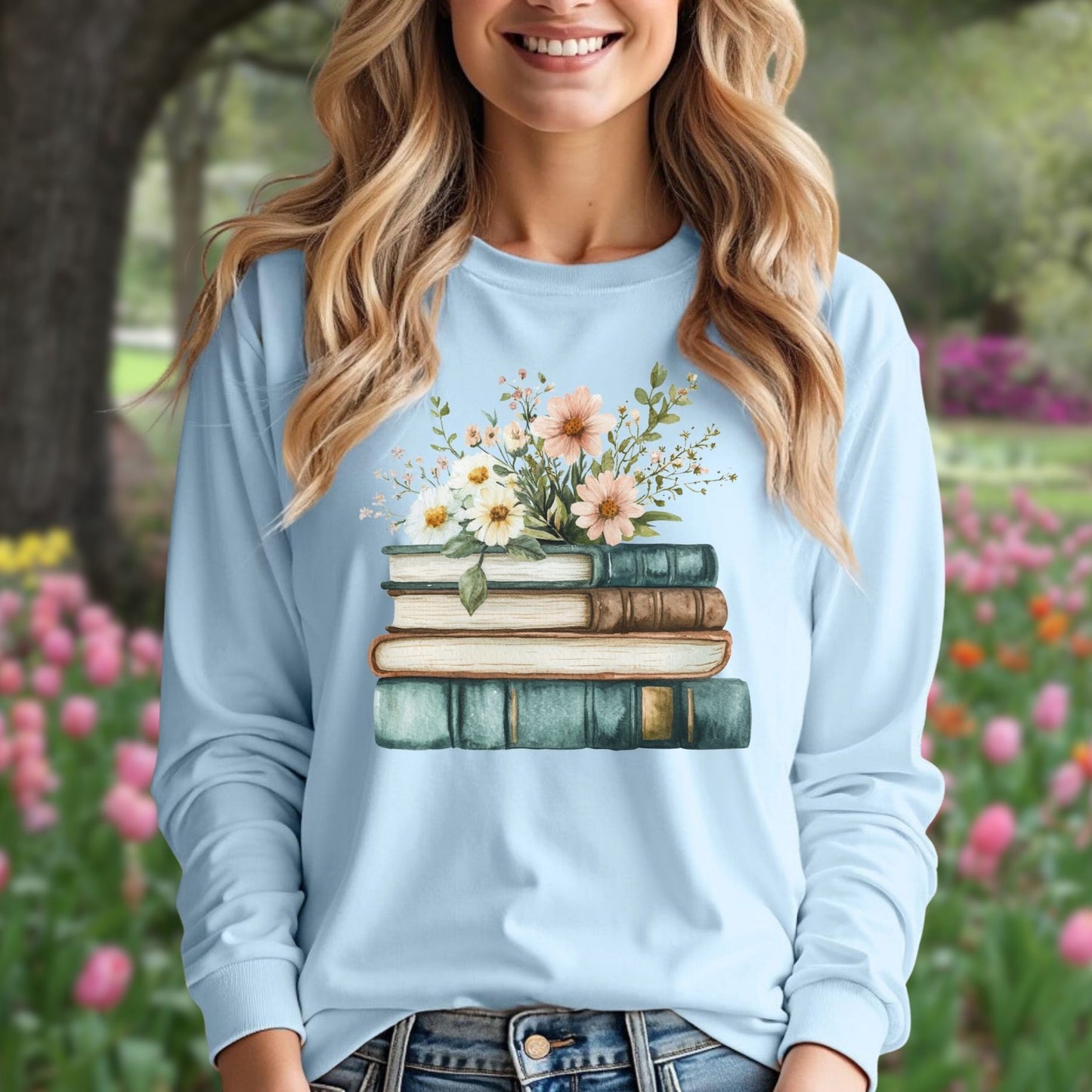 Light blue long-sleeve tee with a vintage stack of books and wildflowers print.