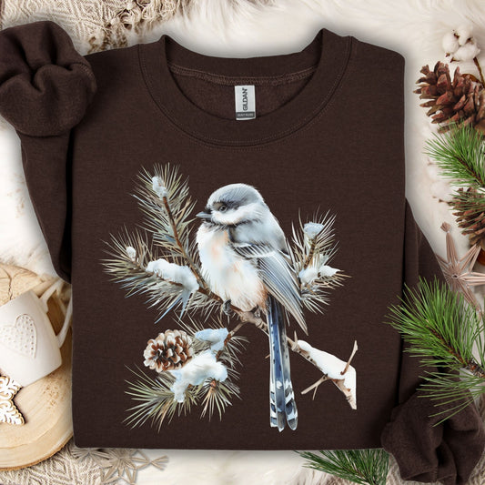 Dark Chocolate Gildan S sweatshirt with a watercolor long-tailed tit on a snowy evergreen bough.