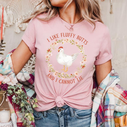 young woman wearing a pink t-shirt with a chicken and floral design, text reads 'I like fluffy butts and I cannot lie'.