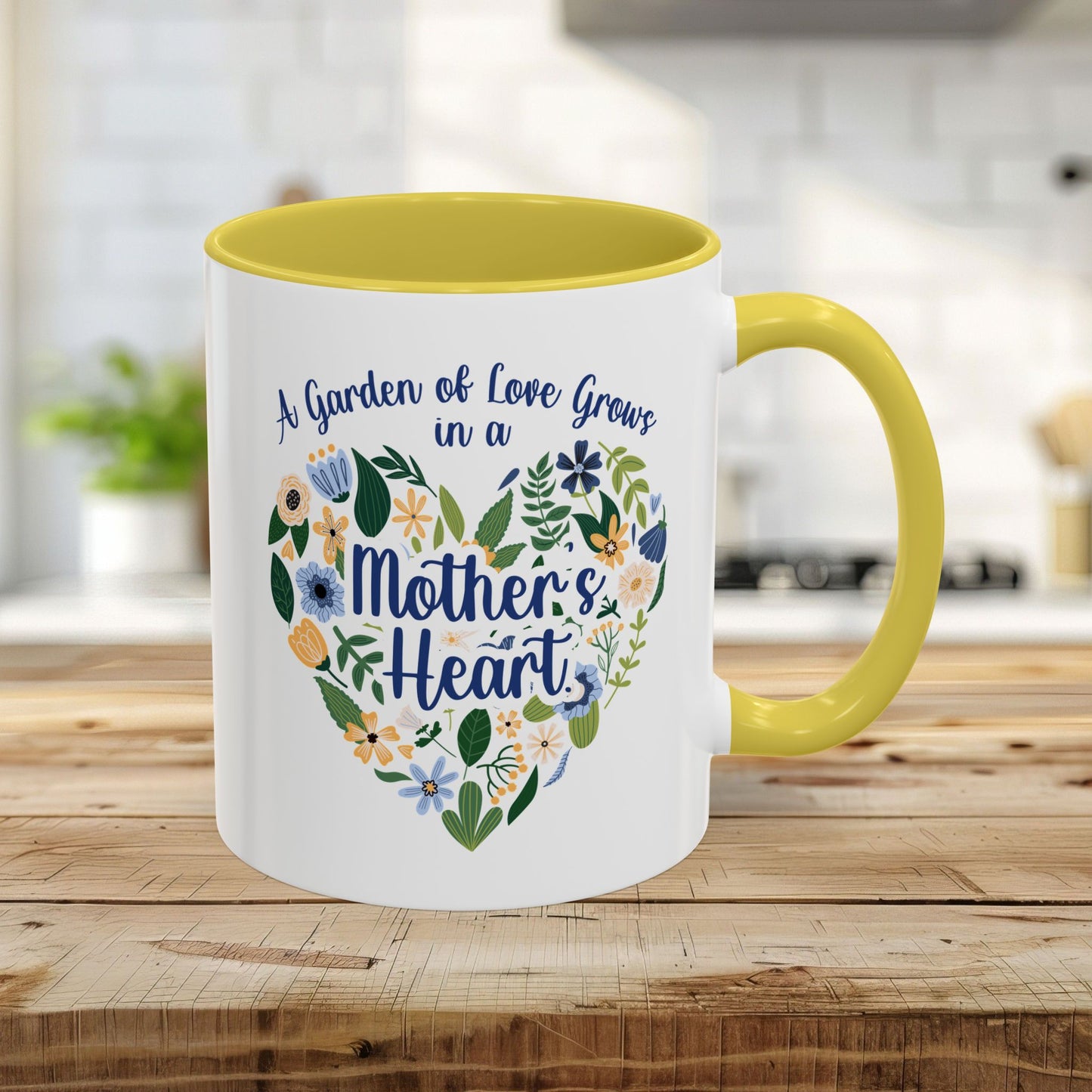 White 11oz ceramic mug with yellow handle and interior, featuring a floral heart design and "A garden of love grows in a Mother's Heart" text.
