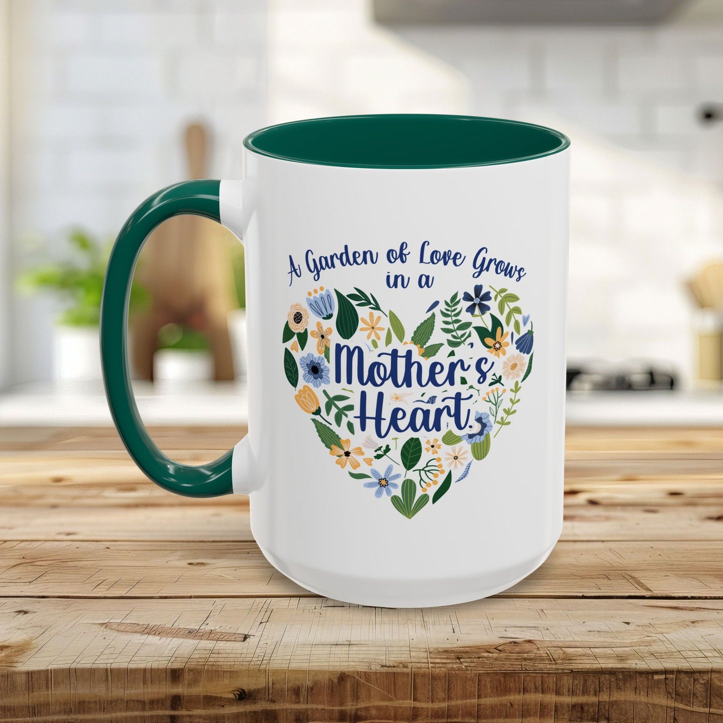 White ceramic mug with green handle and interior, featuring a floral heart design and "A garden of love grows in a Mother's Heart" text.