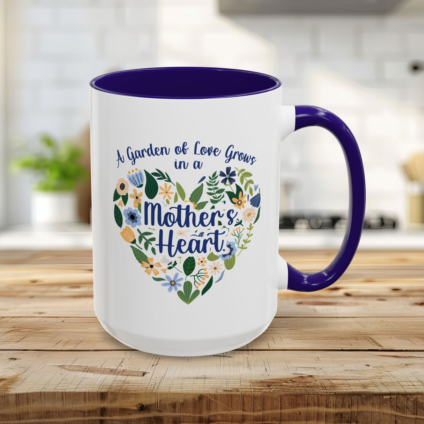 15oz white ceramic mug with blue handle/interior, floral heart, and "A garden of love grows in a Mother's Heart" text.