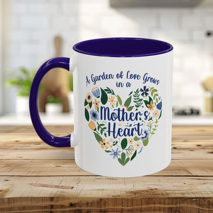 White ceramic mug with purple handle and interior, featuring a floral heart design and "A garden of love grows in a Mother's Heart" text.