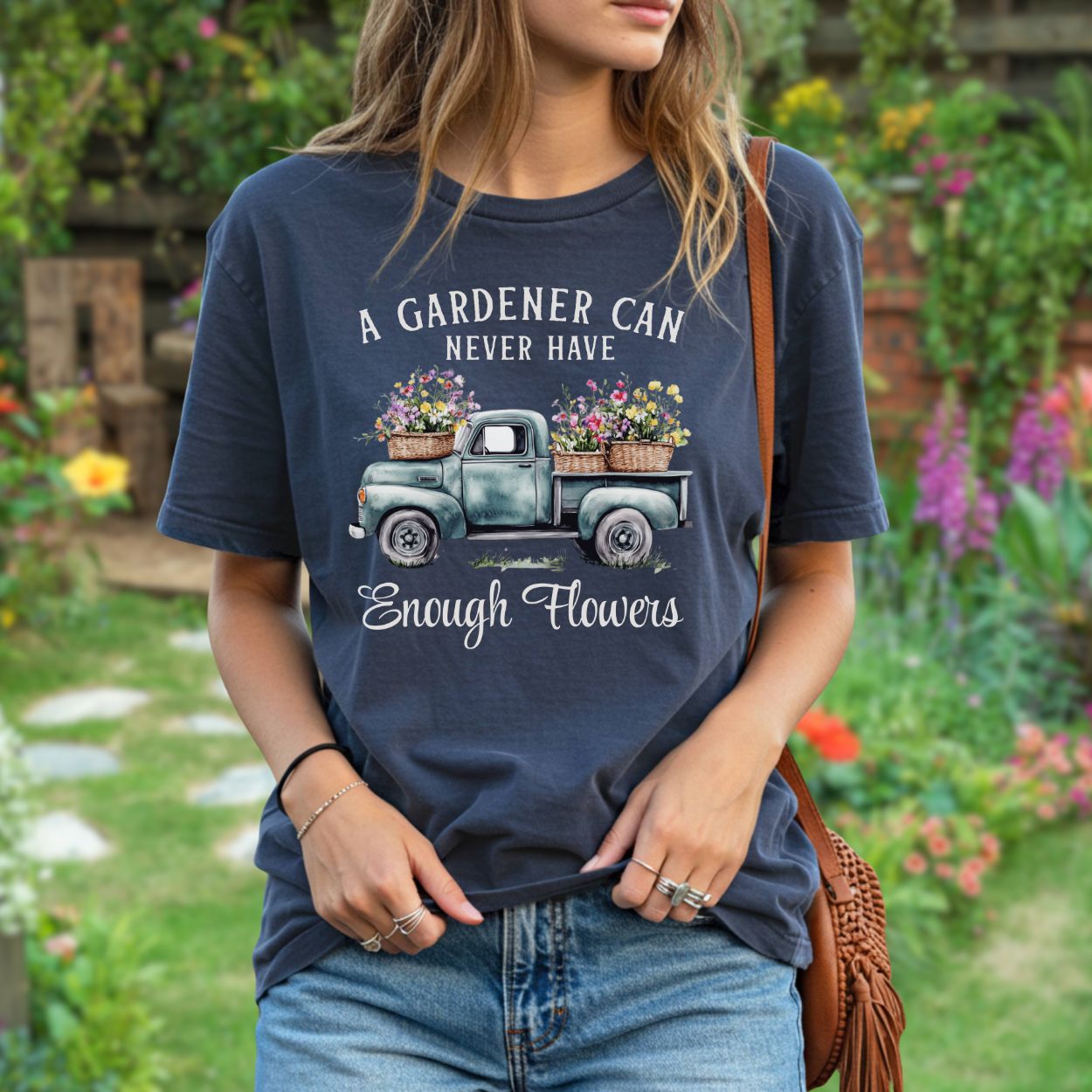 Woman in a navy blue, relaxed-fit cotton t-shirt with a vintage truck spilling watercolor flowers.