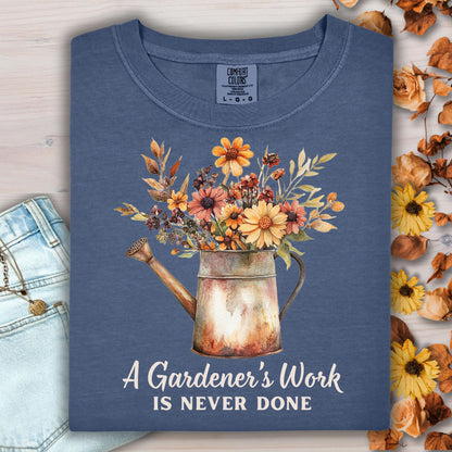 Navy Comfort Colors t-shirt with a watering can full of fall flowers and "A Gardener's Work is Never Done" text.
