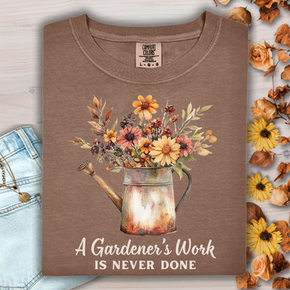 Espresso Comfort Colors tee with a watering can full of fall flowers and "A Gardener's Work Is Never Done" text.