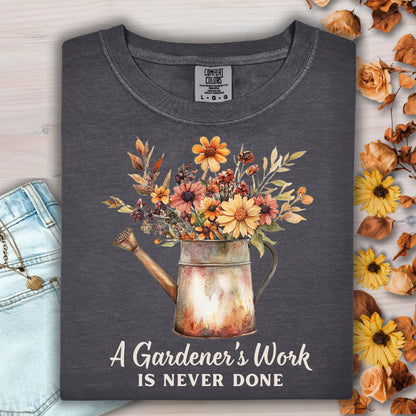 Pepper Comfort Colors t-shirt with a watering can full of fall flowers and "A Gardener's Work Is Never Done" text.
