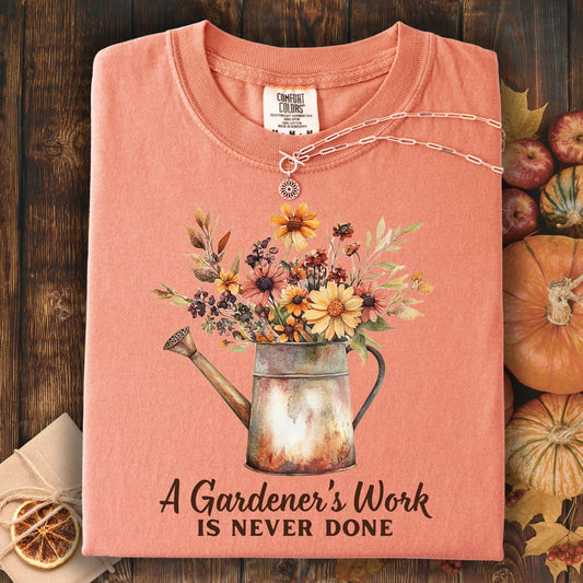 Terracotta Comfort Colors t-shirt with a watering can and floral design, plus "A Gardener's Work is Never Done" text.