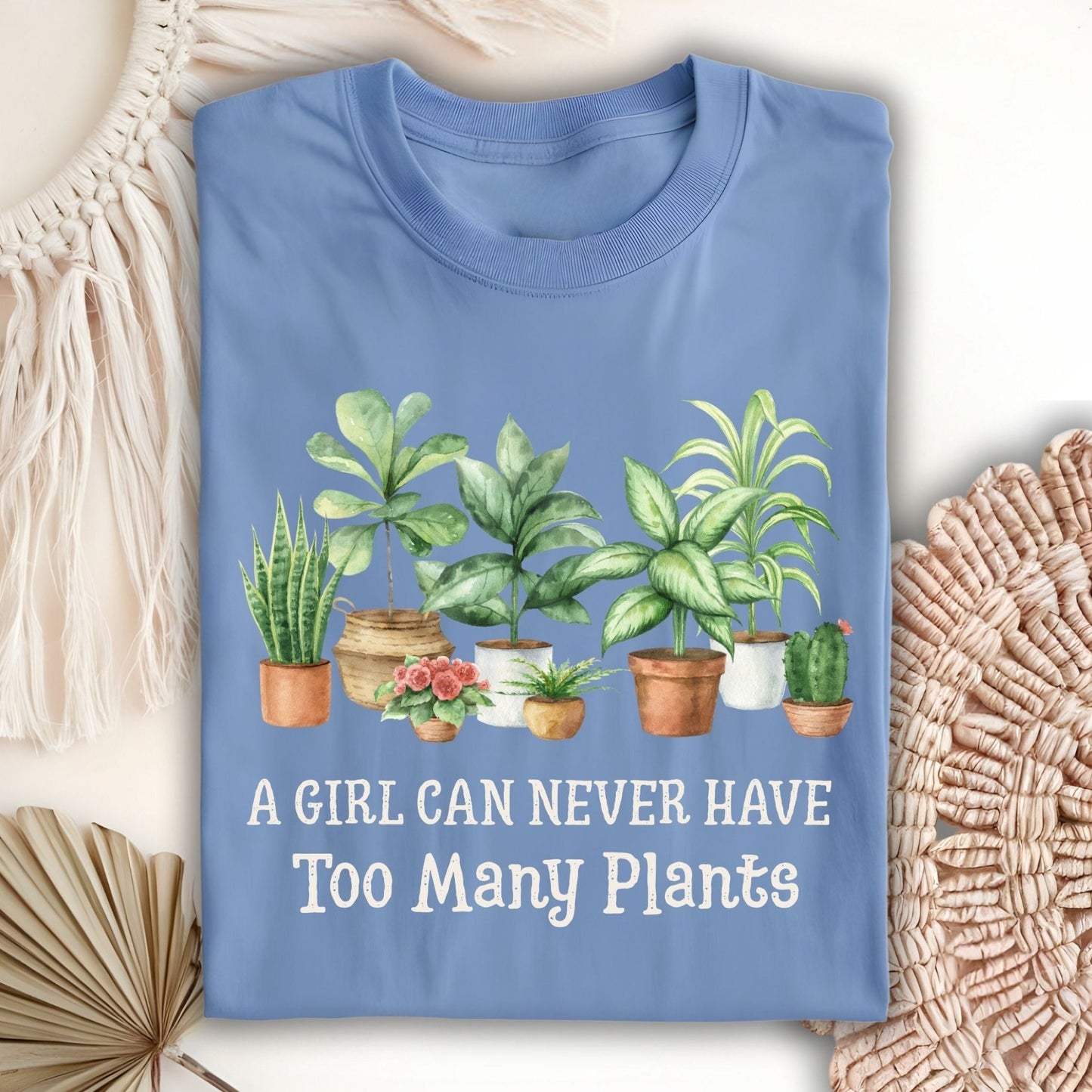 Carolina Blue S t-shirt with "A Girl Can Never Have Too Many Plants" text and watercolor houseplant art.