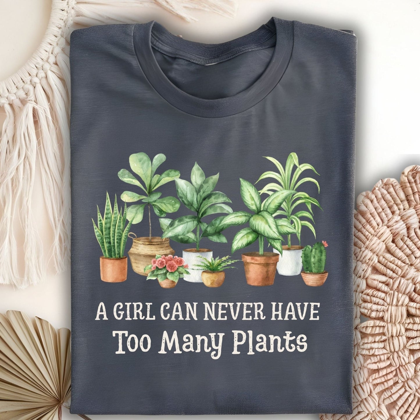Dark Heather S-size t-shirt with "A Girl Can Never Have Too Many Plants" text and watercolor houseplant art.