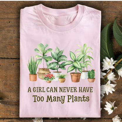 Light pink "A Girl Can Never Have Too Many Plants" t-shirt with watercolor houseplant art.