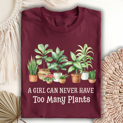 Maroon S-size t-shirt with "A Girl Can Never Have Too Many Plants" text and watercolor houseplant art.